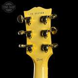 Gibson guitar headstock with tuning pegs on a black background