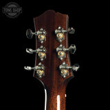 Close-up of a guitar headstock with tuning pegs on a black background, featuring the Tone Shop logo.