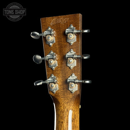 Guitar headstock with tuning pegs on a black background, featuring the 'Tone Shop' logo.