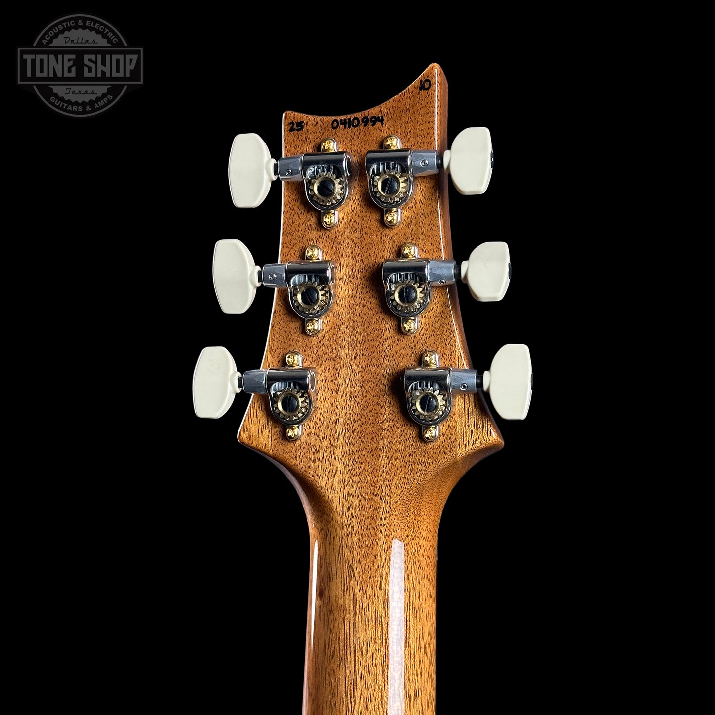 Guitar headstock with tuning pegs on a black background, featuring 'Tone Shop' logo.