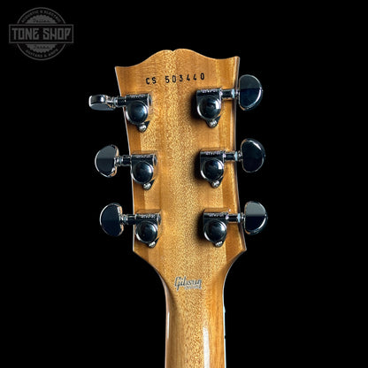 Gibson guitar headstock with tuning pegs on a black background