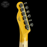 Guitar headstock with tuning pegs on a black background, featuring the Tone Shop logo.