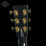 Guitar headstock with gold tuning pegs on a black background, featuring 'Tone Shop' logo.