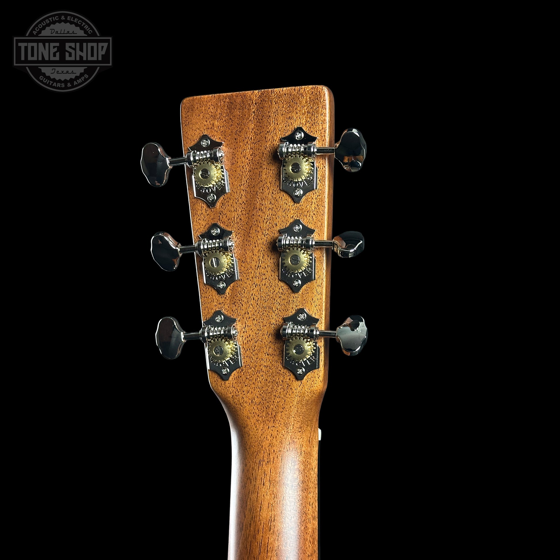 Guitar headstock with tuning pegs on a black background, featuring the Tone Shop logo.