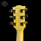 Gibson guitar headstock with tuning pegs on a black background