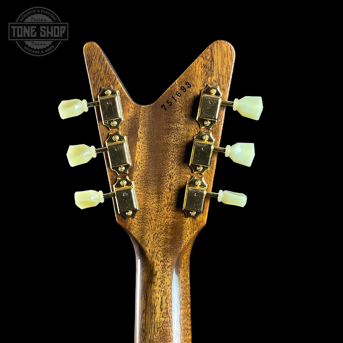 Close-up of a guitar headstock with 'Tone Shop' logo in the corner.