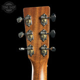 Close-up of a guitar headstock with tuning pegs on a black background, featuring the Tone Shop logo.
