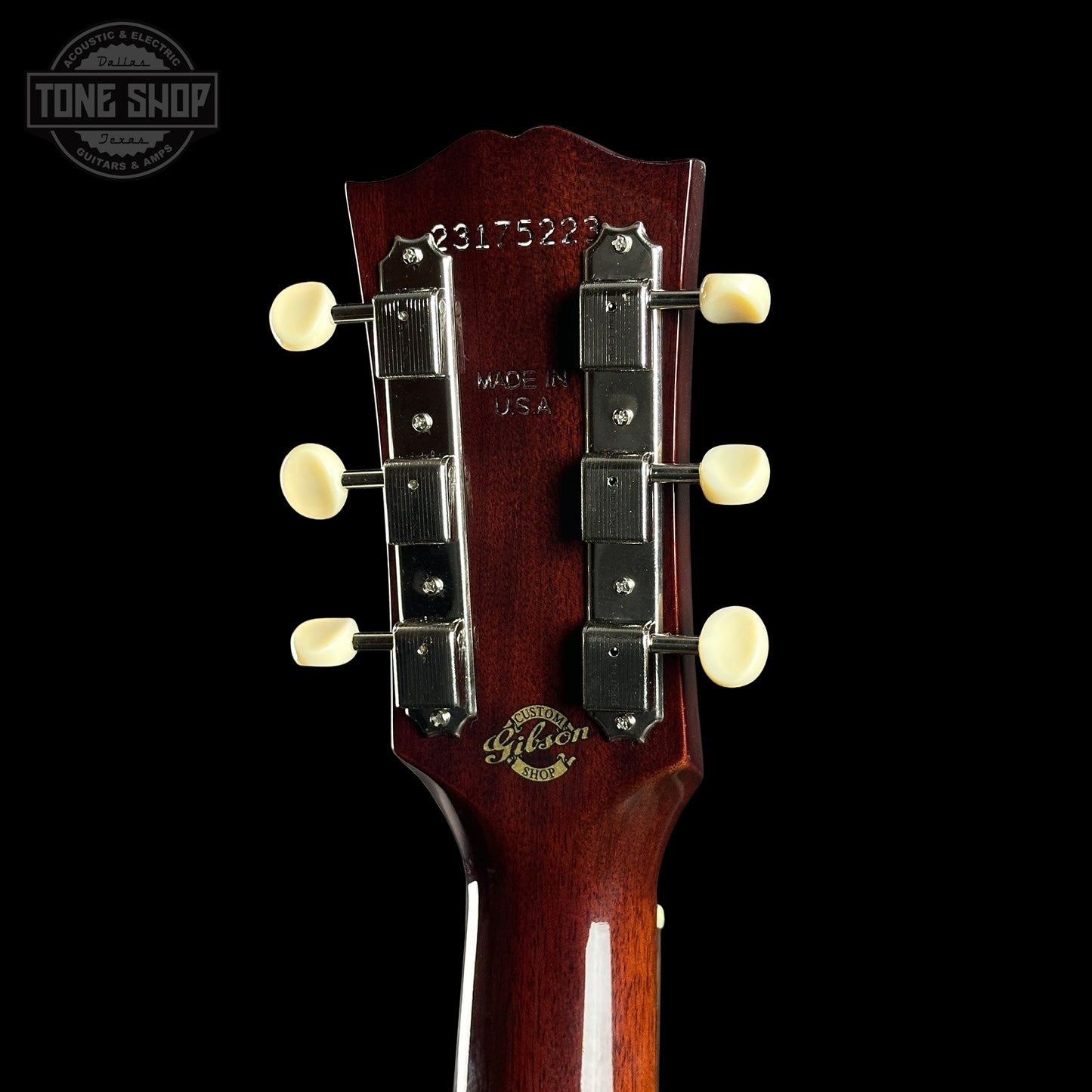 Gibson guitar headstock with brand logo on a black background