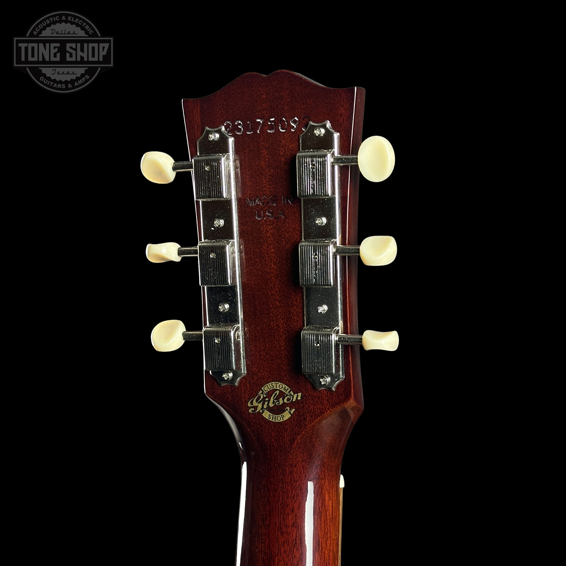 Gibson guitar headstock with brand logo on a black background