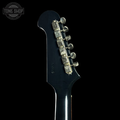 Close-up of a guitar headstock with tuning pegs on a black background, featuring 'Tone Shop' branding.
