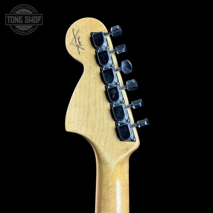 Guitar headstock with tuning pegs on a black background, featuring the Tone Shop logo.