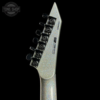 Close-up of a guitar's tuning pegs with a black background
