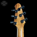 Guitar headstock with tuning pegs on a black background, featuring the Tone Shop logo.
