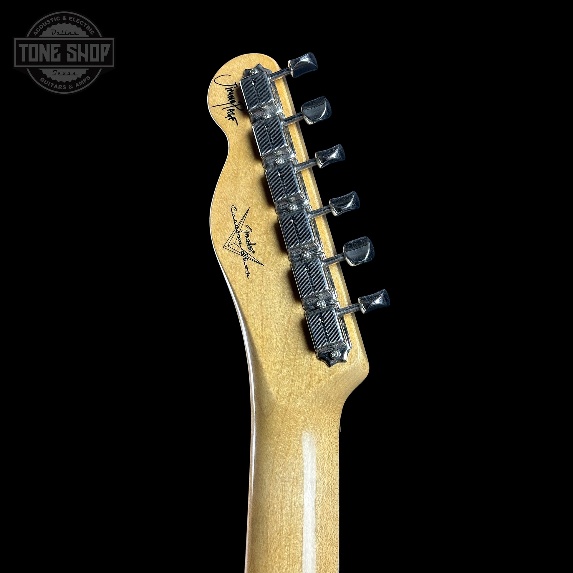 Guitar headstock with tuning pegs on a black background, featuring the Tone Shop logo.