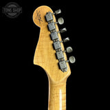 Guitar headstock with tuning pegs on a black background, featuring the Tone Shop logo.
