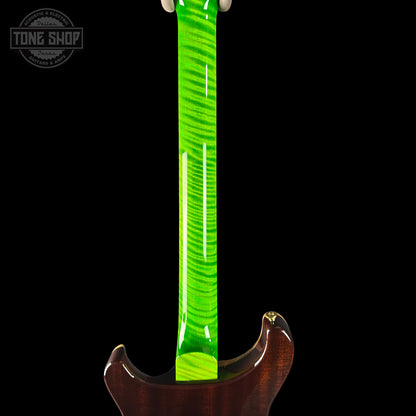 Guitar neck with green fretboard and wooden body on a black background, featuring 'Tone Shop' logo.