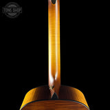 Close-up of a wooden guitar neck and body with 'Tone Shop' branding.