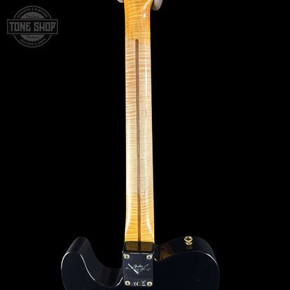Guitar neck with a black body on a black background, featuring the Tone Shop logo.