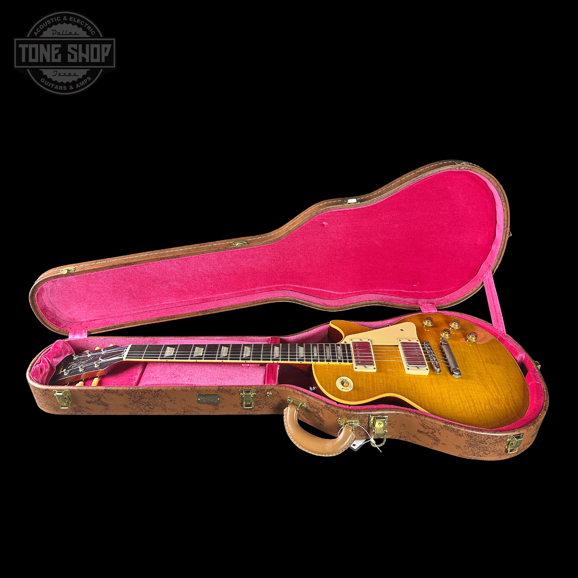 Gibson Les Paul guitar in a pink case with 'Tone Shop' logo.