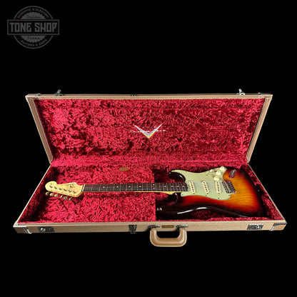Fender Stratocaster guitar in a red-lined case with 'Tone Shop' logo.