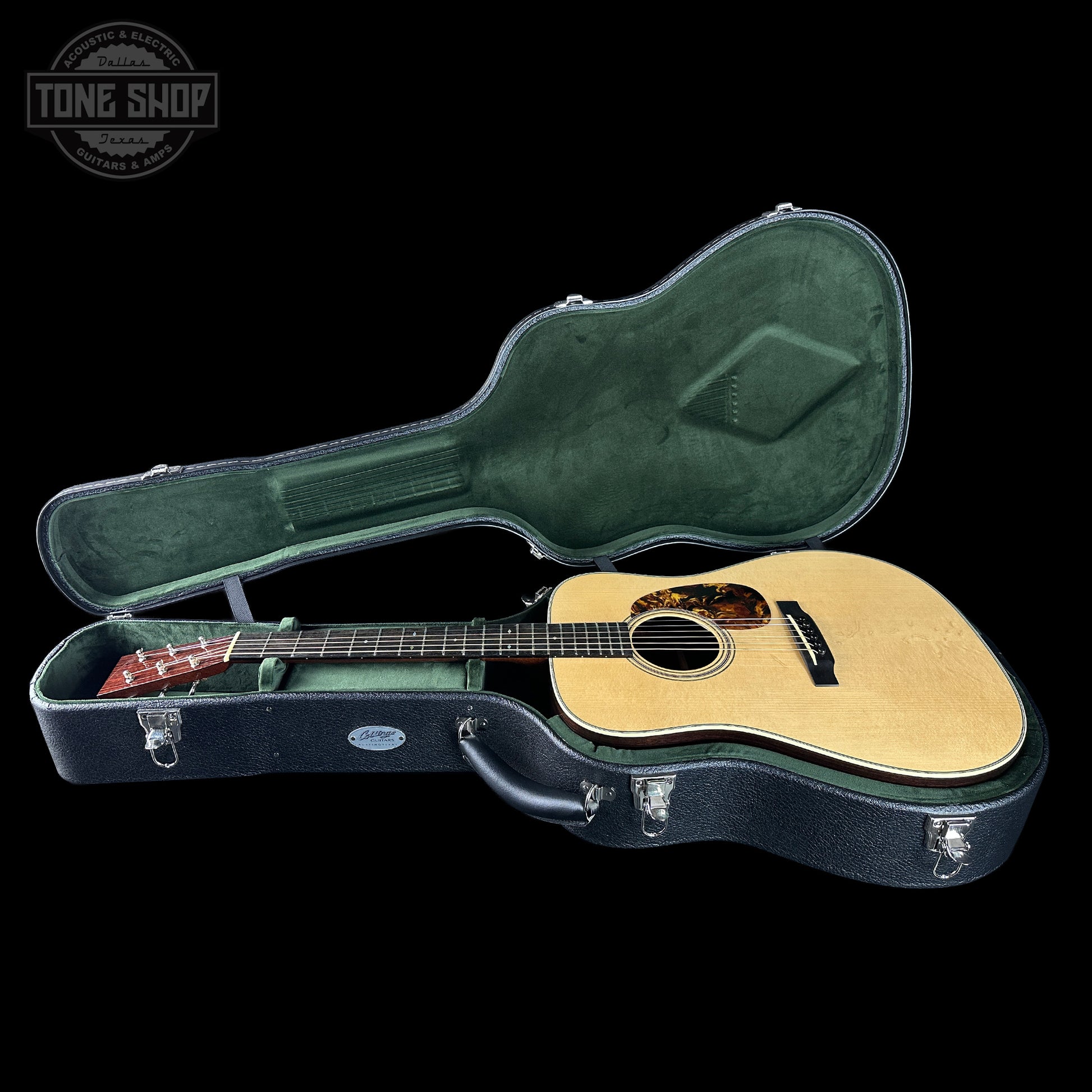 Acoustic guitar in a hard-shell case with 'Tone Shop' logo.