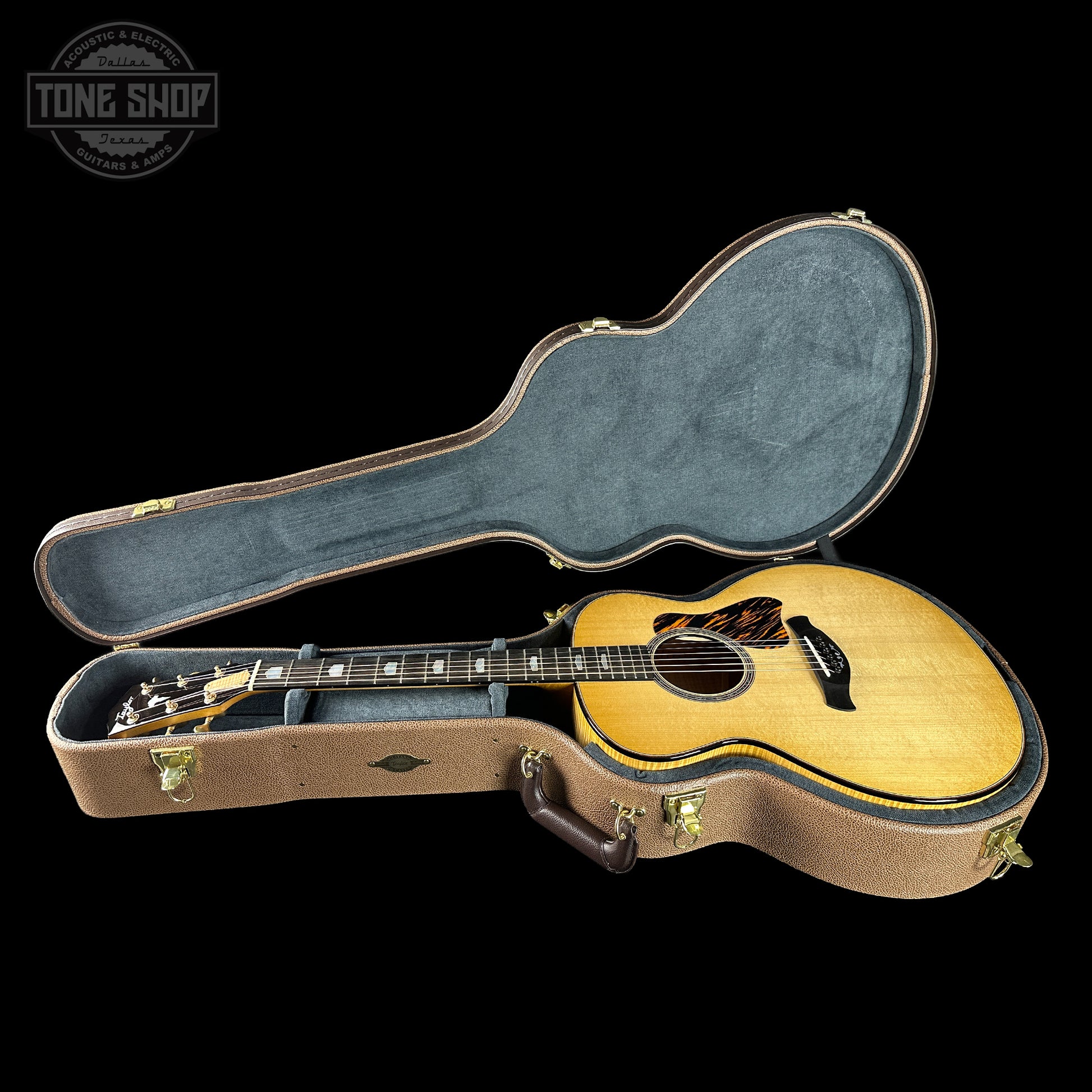 Acoustic guitar in a hard-shell case with 'Tone Shop' logo in the corner.