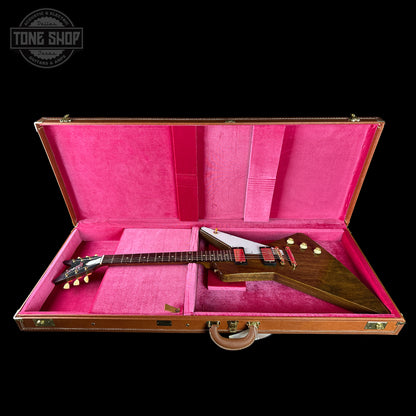 Guitar in a pink case with 'Tone Shop' logo in the corner