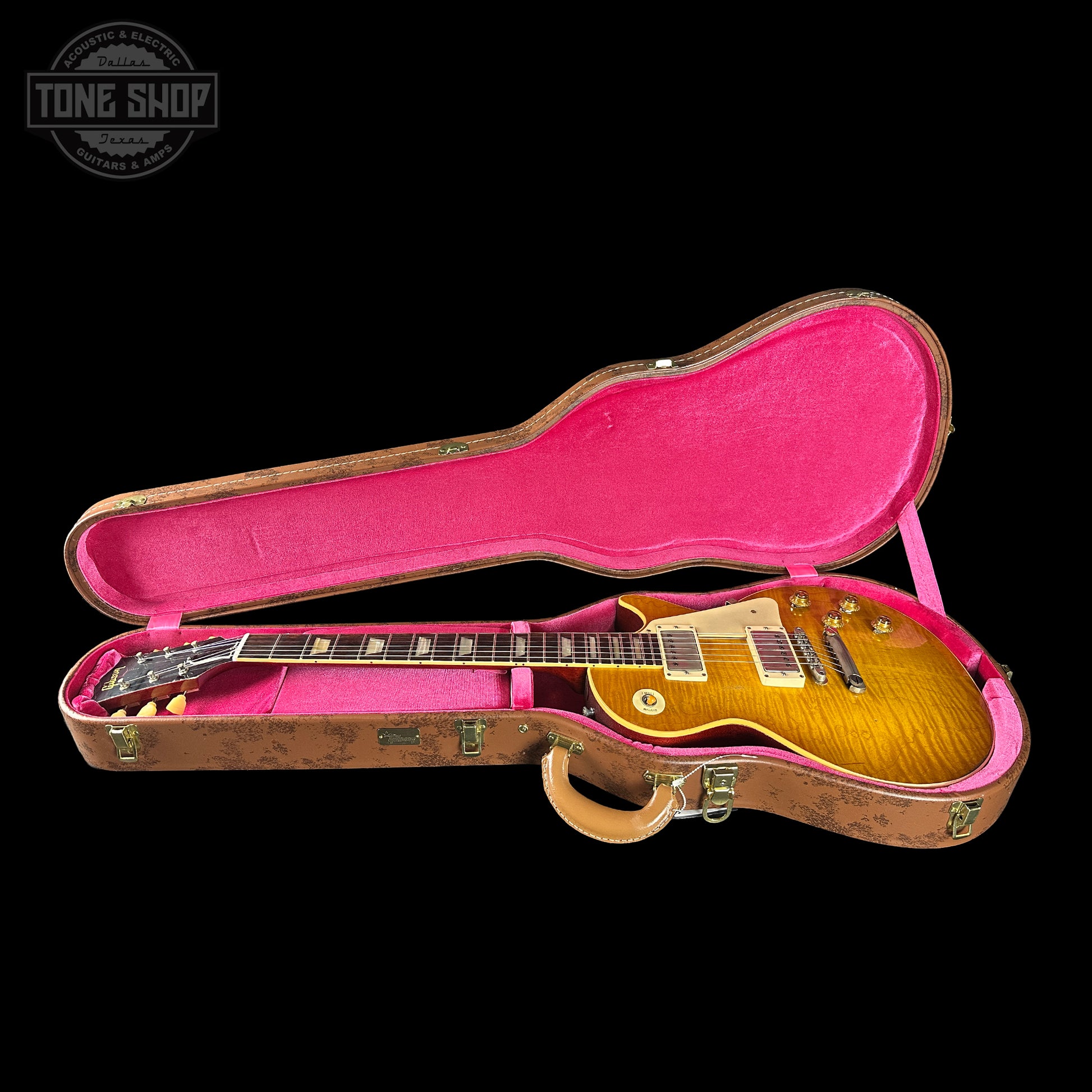 Gibson Les Paul guitar in a pink-lined case with 'Tone Shop' logo.