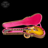 Gibson Les Paul guitar in a pink-lined case with 'Tone Shop' logo.