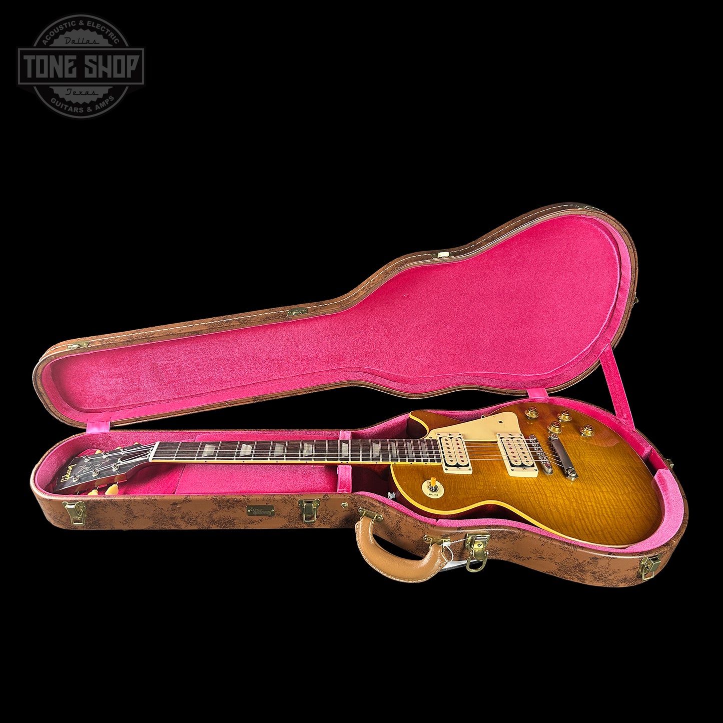 Gibson Les Paul guitar in a pink-lined case with 'Tone Shop' logo.