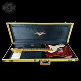 Fender electric guitar in a gold case with 'Tone Shop' logo.