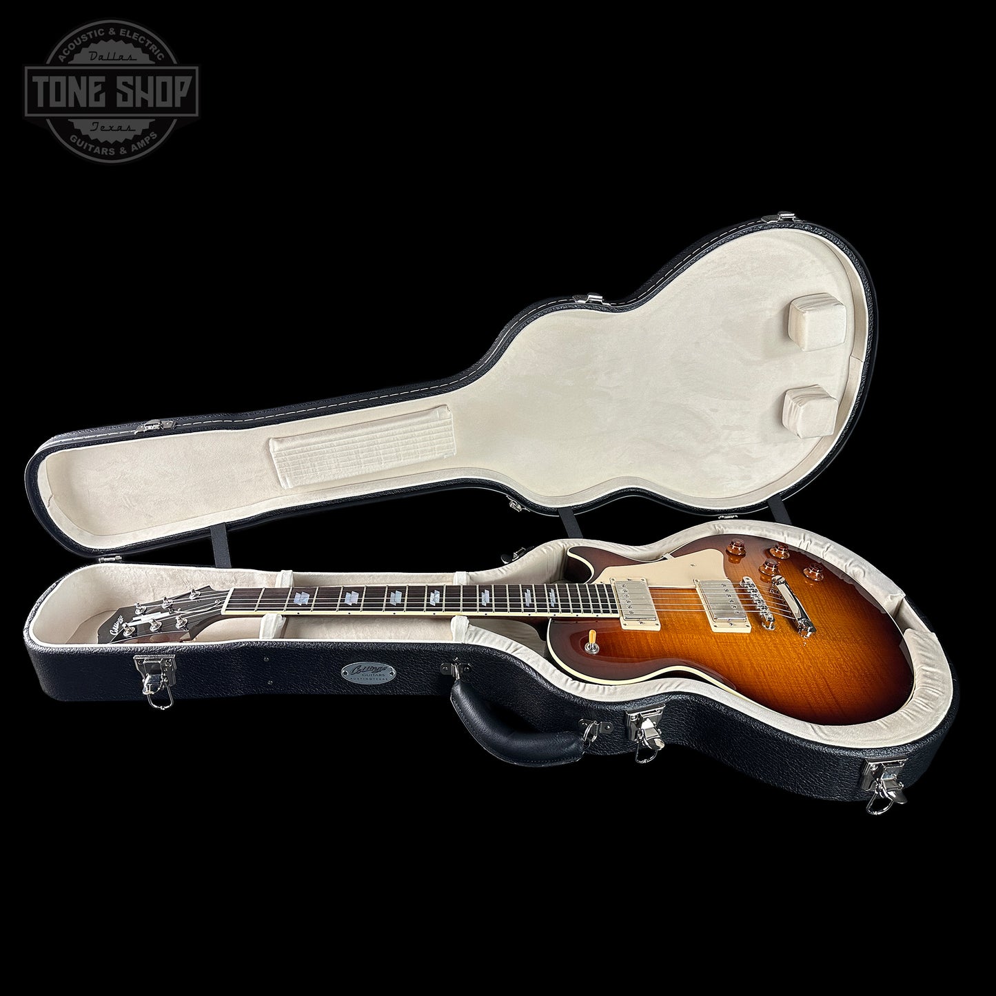 Gibson Les Paul guitar in a hard-shell case with 'Tone Shop' logo.