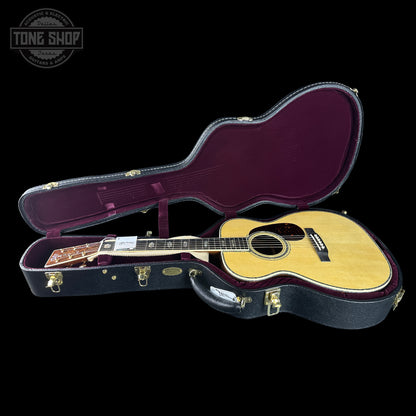 Acoustic guitar in a case with 'Tone Shop' logo in the corner