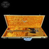 Guitar in an open case with a visible brand logo on a black background