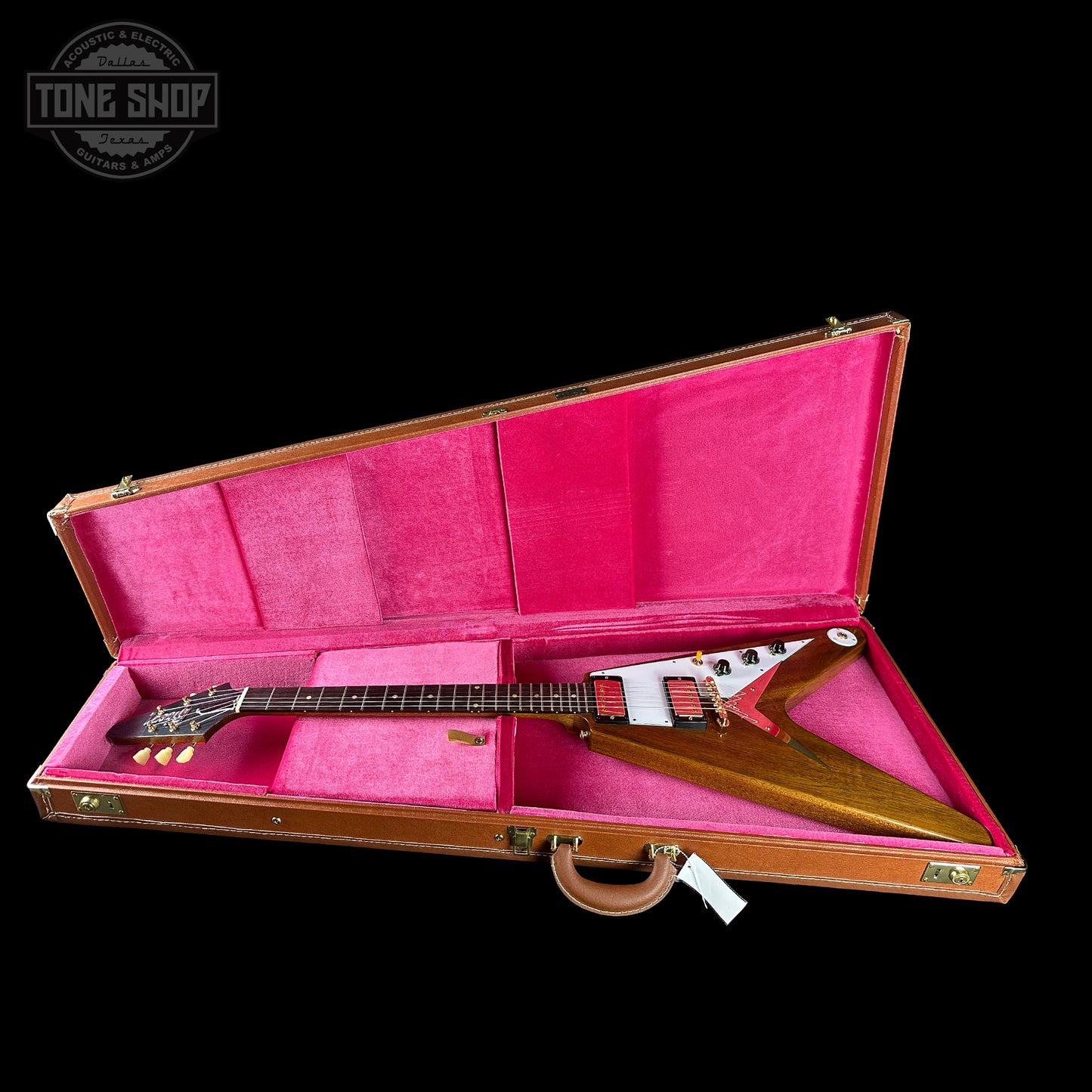 Guitar in a pink-lined case with 'Tone Shop' logo in the corner.
