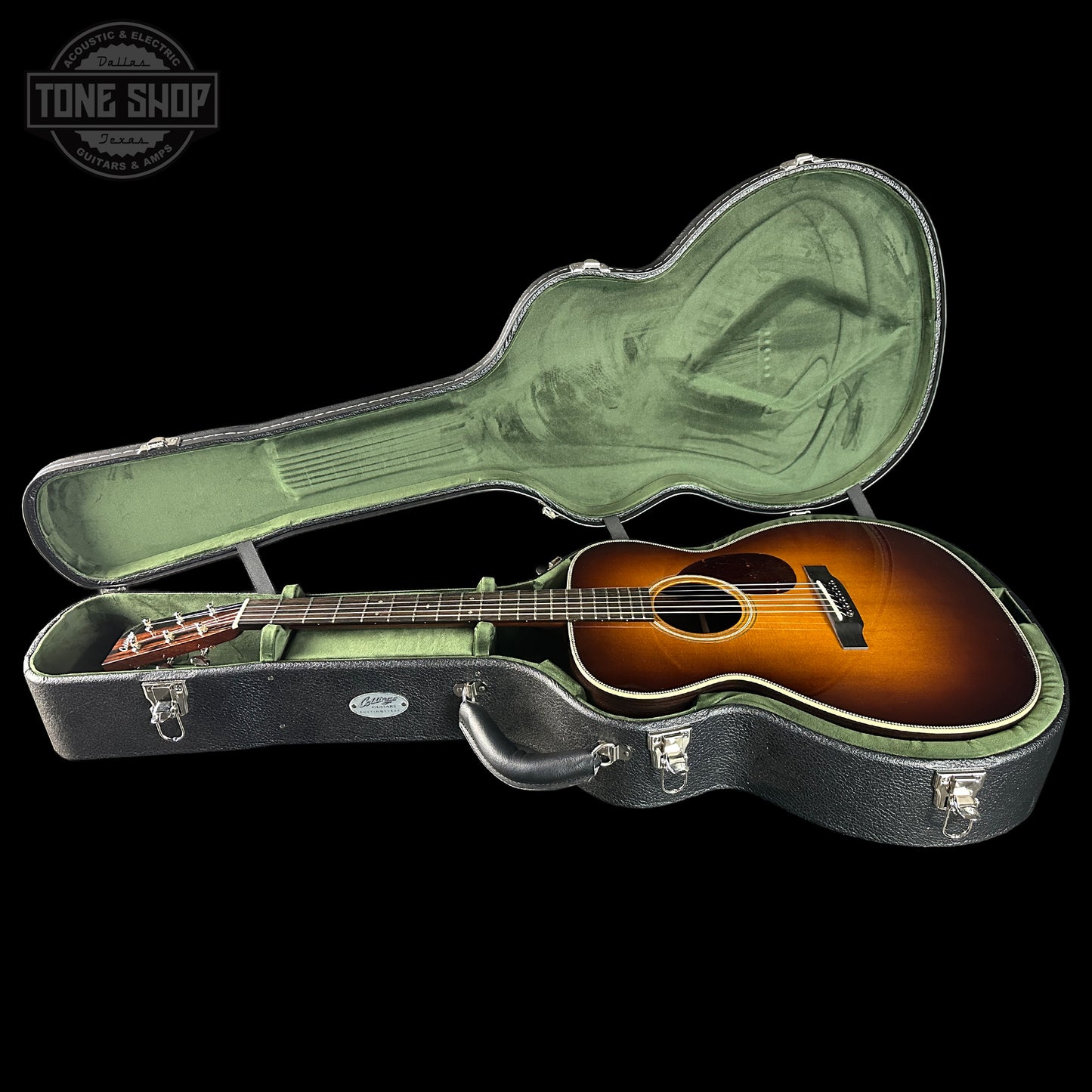 Acoustic guitar in a hard-shell case with 'Tone Shop' logo.