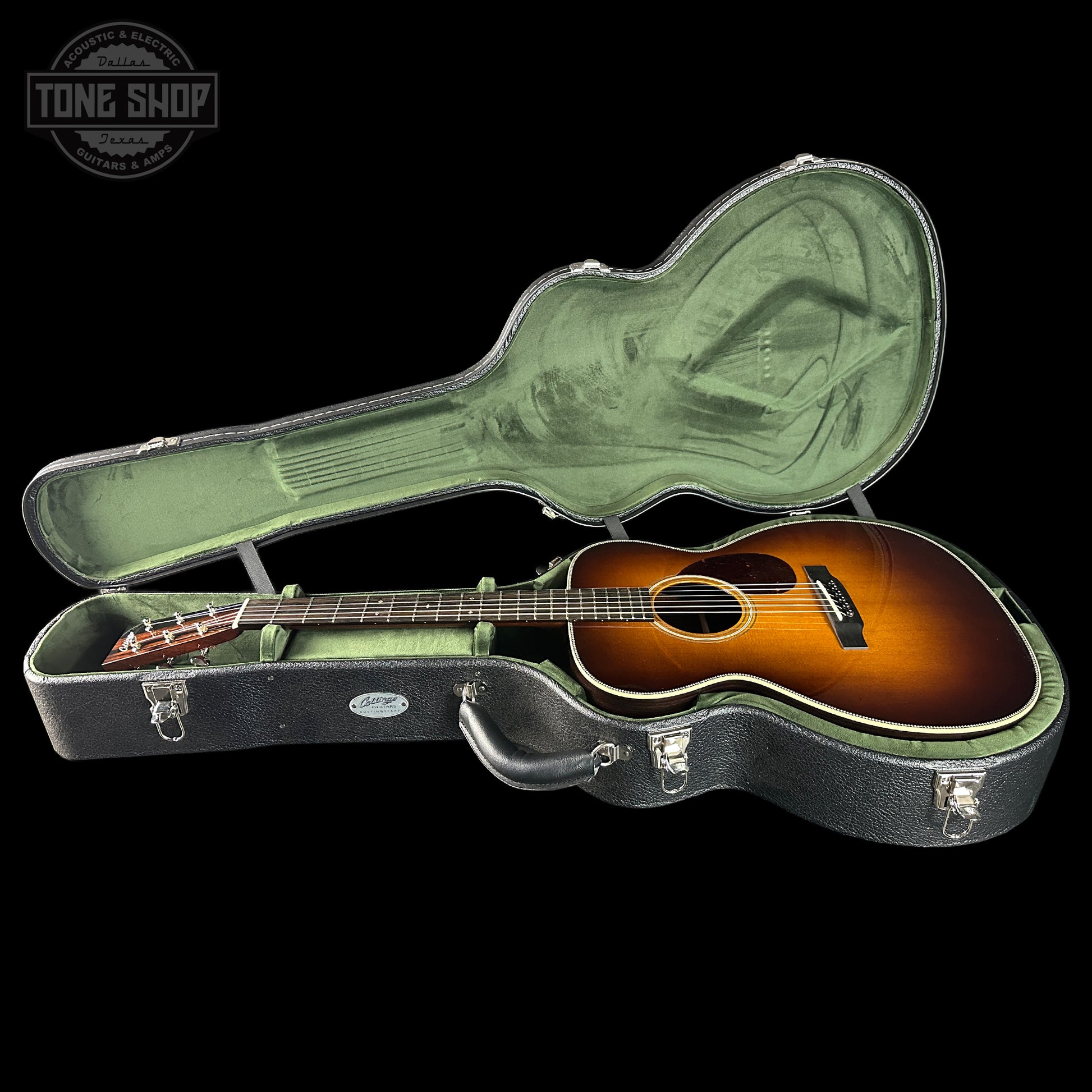Acoustic guitar in a hard-shell case with 'Tone Shop' logo.
