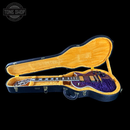 Guitar in an open case with a visible 'Tone Shop' logo.