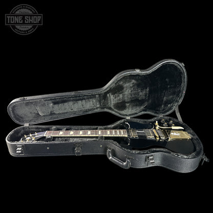 Guitar in a black case with 'Tone Shop' logo in the corner