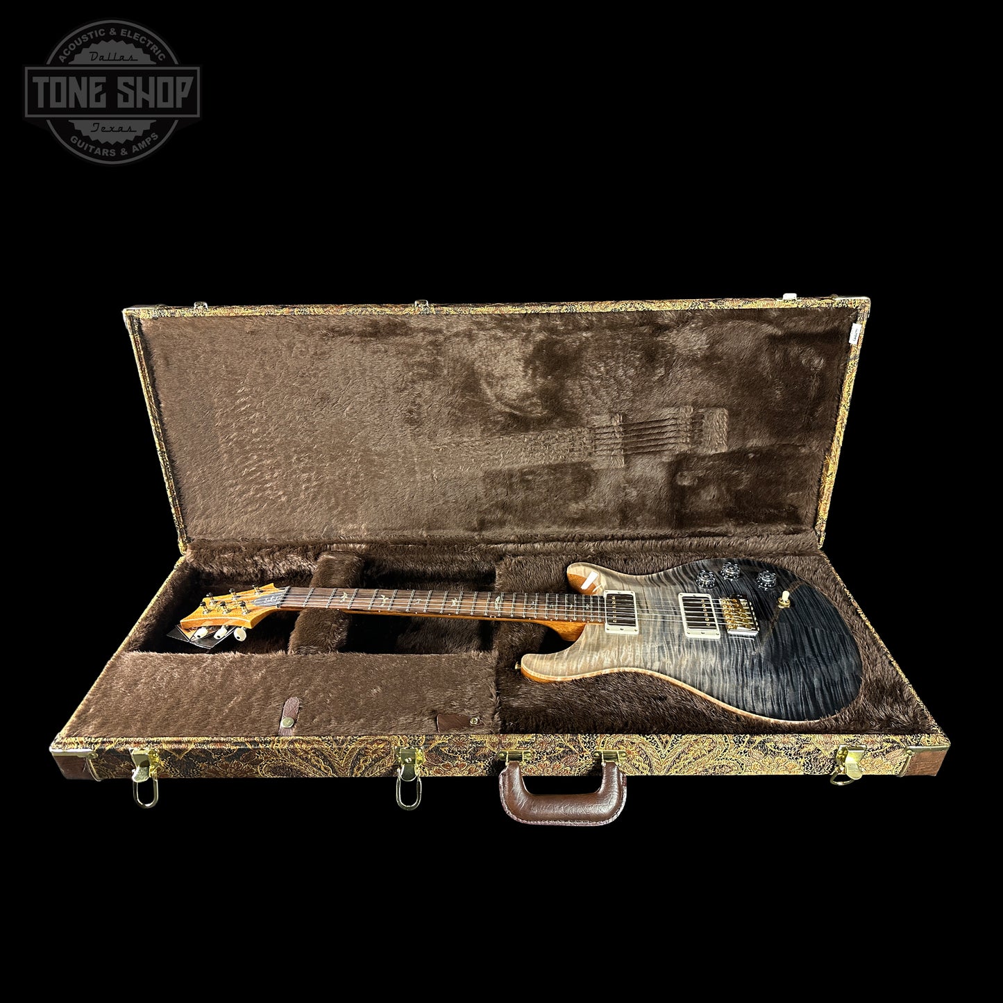 Electric guitar in a case with 'Tone Shop' logo in the corner