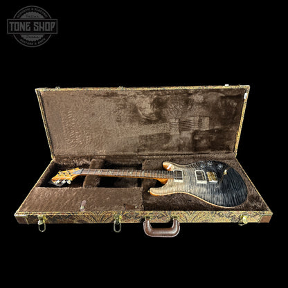 Electric guitar in a case with 'Tone Shop' logo in the corner