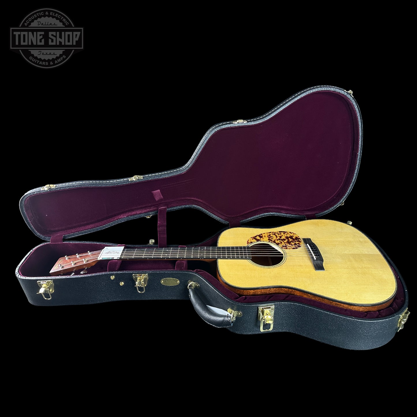 Acoustic guitar in an open case 