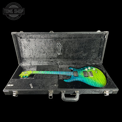 Colorful electric guitar in a hard-shell case with 'Tone Shop' branding.