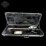 Electric guitar in a hard-shell case with 'Tone Shop' logo.