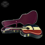 Guitar in an open case with 'Tone Shop' logo in the corner