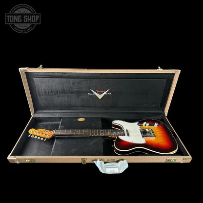 Electric guitar in a case with a visible brand logo on a black background