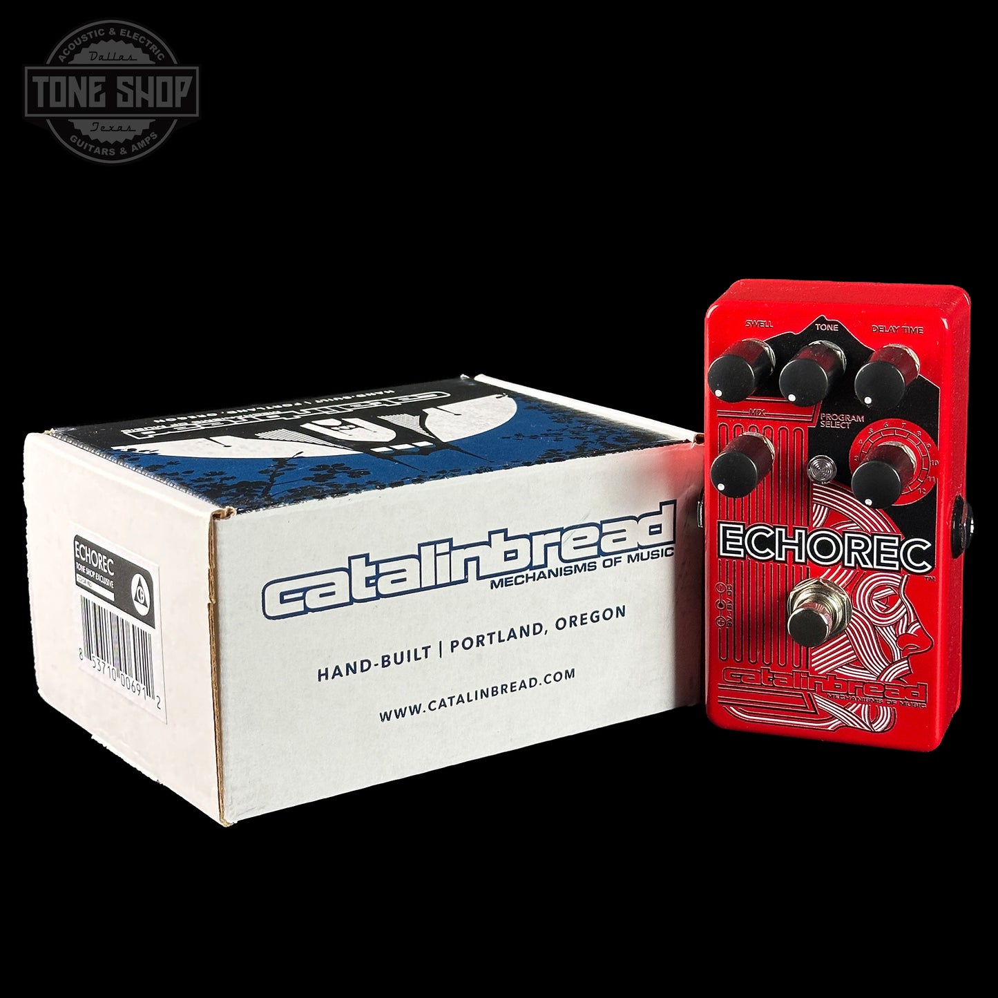 Red Catalinbread Echorec guitar effects pedal next to its packaging box on a black background.