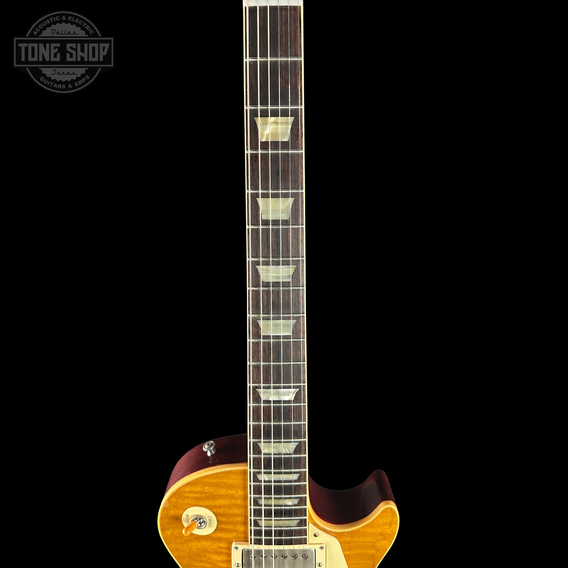 Close-up of a guitar neck with a visible brand logo in the corner.