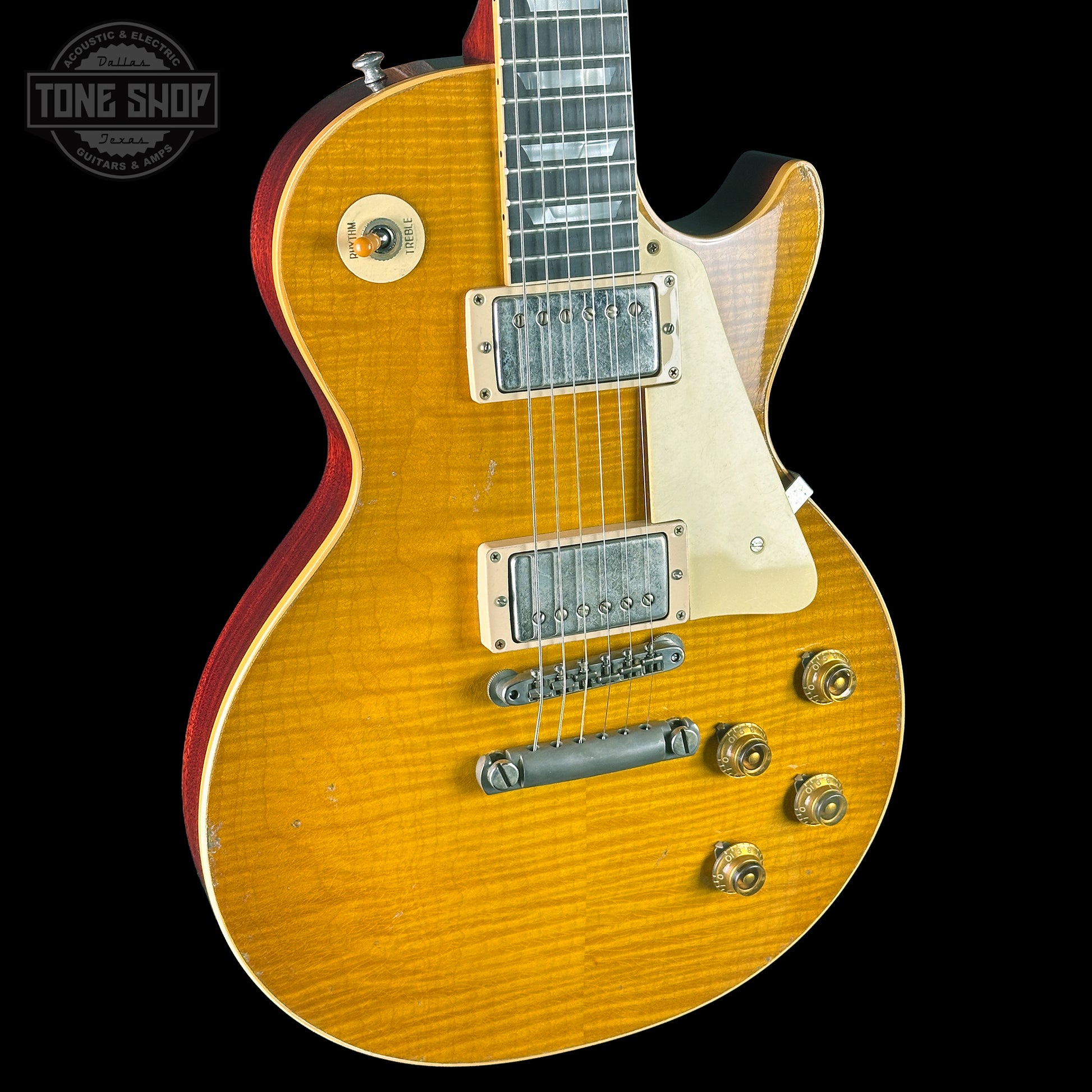 Electric guitar with a sunburst finish on a black background, featuring the Tone Shop logo.