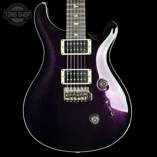 Purple electric guitar with a black background